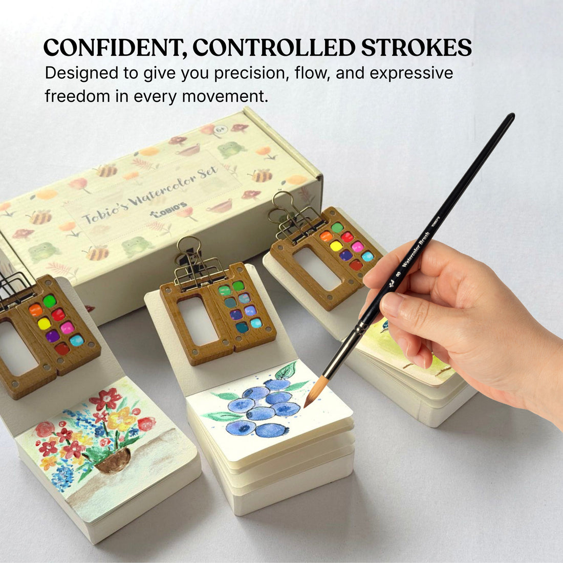 Person painting different floral pieces with Tobio’s Watercolor Kit