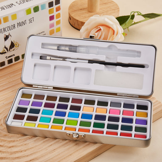 Open Tobio's watercolor paint set in a metal tin with colorful pans, brush, water pen, and mixing wells