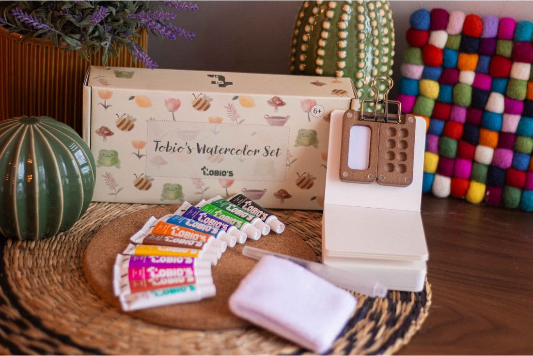 Tobio’s Watercolor set, complete with 12 paint pieces, a waterbrush, a wooden palette, a wristband, and a workbook