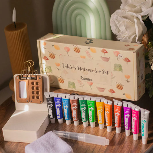 Tobio's Watercolor Set with its illustrated box, walnut palette, 12 paint tubes, and water brush.