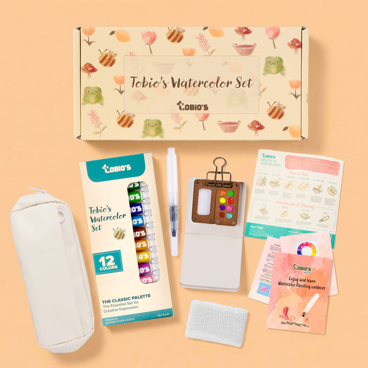Tobio's Watercolor Set with various items on a peach background