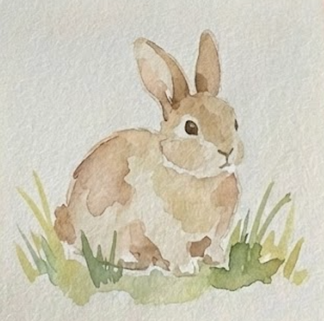 Finished loose bunny watercolor painting with green grass and sepia facial details.