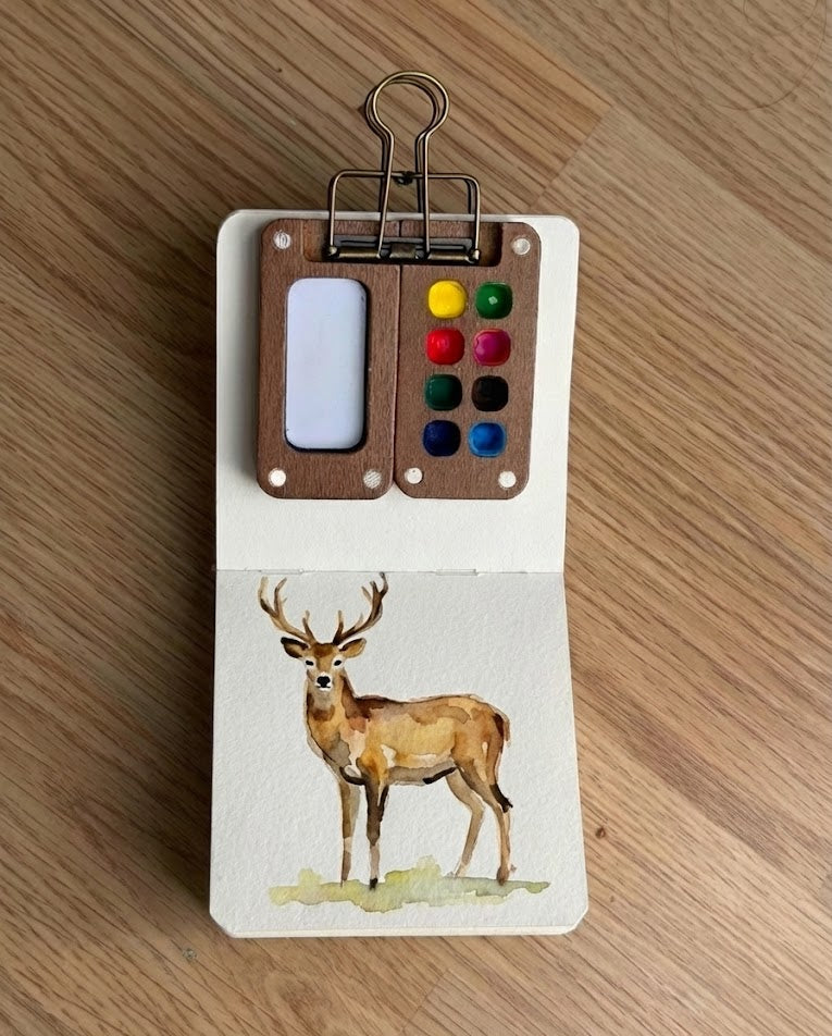 Tobio’s Kits deer watercolor painting, painted in a small watercolor sketchbook with soft washes and simple details.