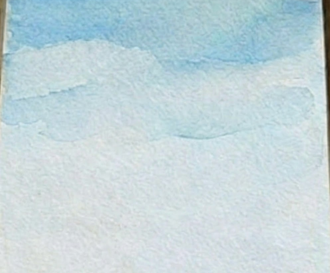 A light blue sky wash for step one of a loose desert watercolor painting.