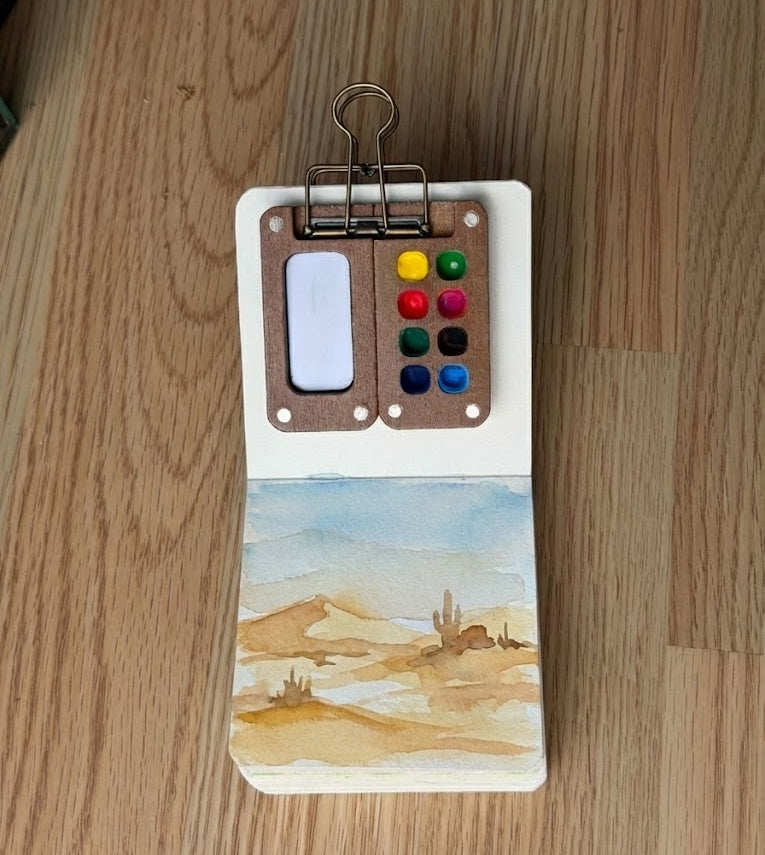 Small art book with a desert watercolor painting
