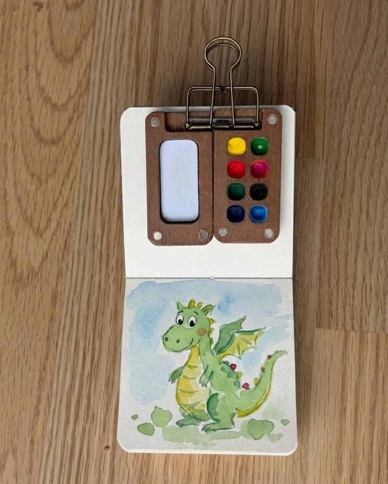 Tobio’s Kits dragon watercolor painting, painted in a small watercolor sketchbook with simple details.