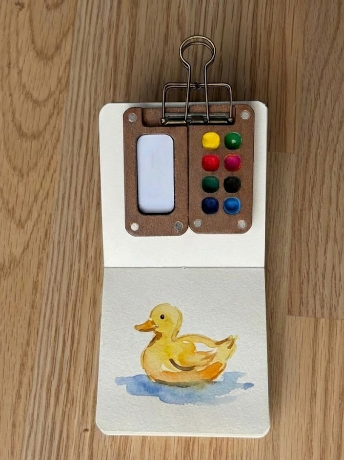 duck watercolor painting, painted in a small watercolor sketchbook with soft washes and simple details.