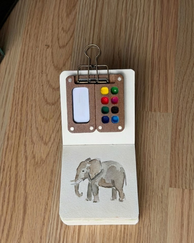 Tobio’s Kits elephant watercolor painting, painted in a small watercolor sketchbook with soft washes and simple details.