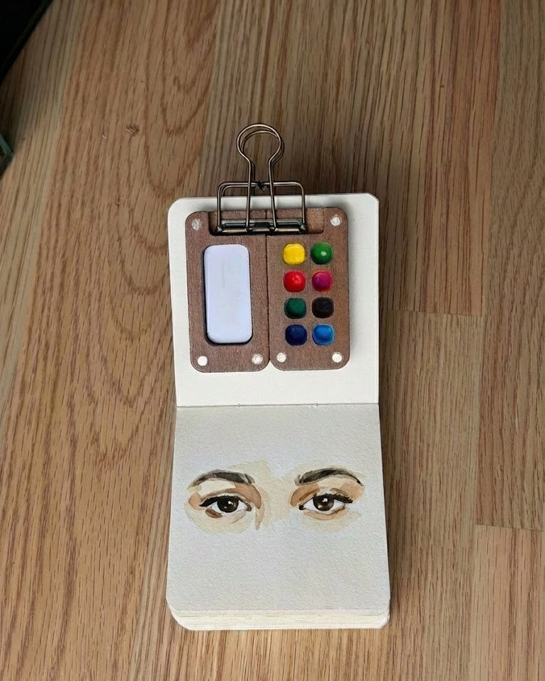 Tobio’s Kits eyes watercolor painting, showing detailed iris and soft washes in a sketchbook.