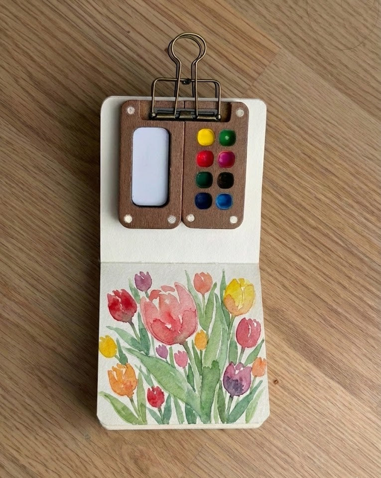 Tobio’s Kits floral watercolor painting, painted in a small watercolor sketchbook with soft washes.