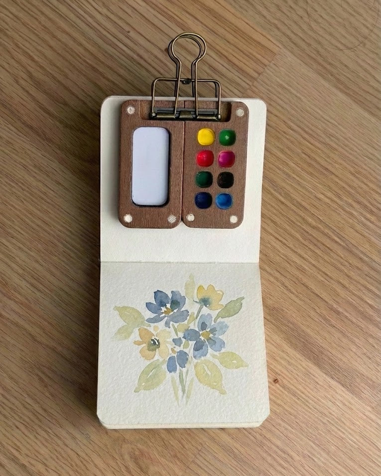 Tobio’s Kits watercolor flower painting, painted in a small watercolor sketchbook with soft washes and simple details.
