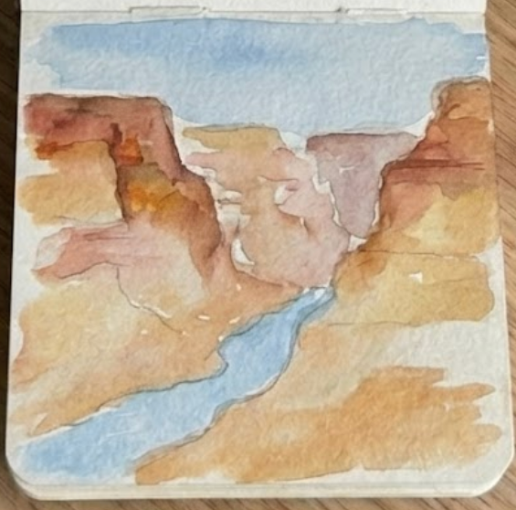 Progress shot of a grand canyon watercolor painting, showing warm earth-toned washes and shadows defining the canyon walls.