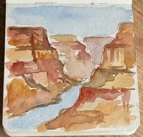 Completed grand canyon watercolor painting in a sketchbook, featuring detailed rock layers, a winding river, and a blue sky.