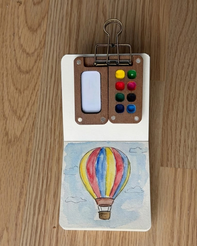 Tobio’s Kits hot air balloon watercolor painting, painted in a small watercolor sketchbook.