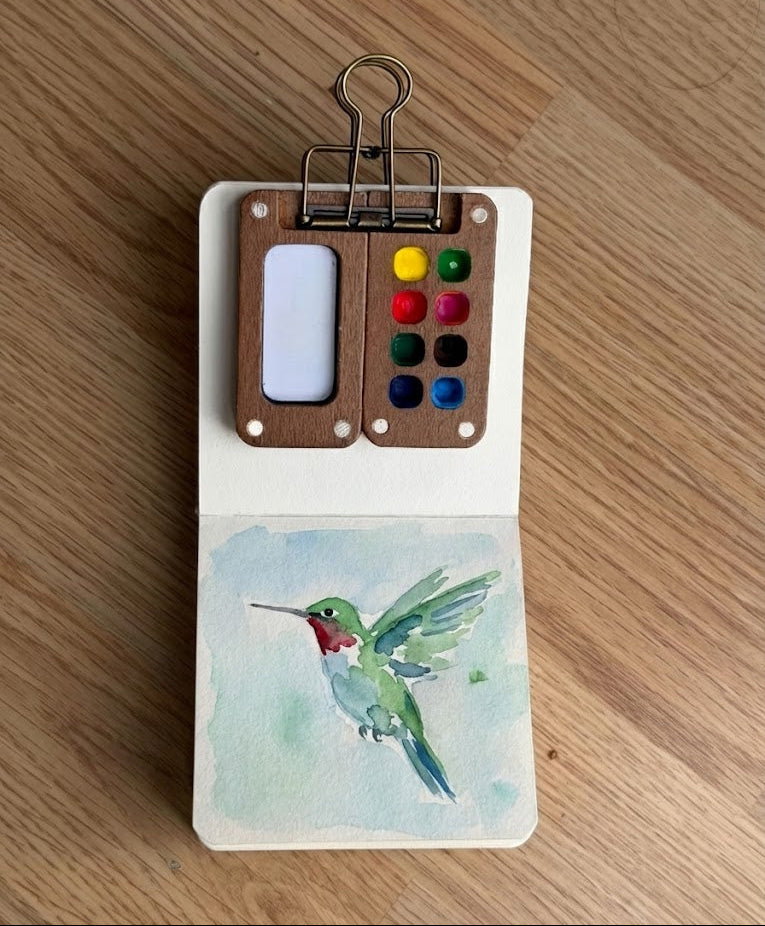 A watercolor painting of a hummingbird