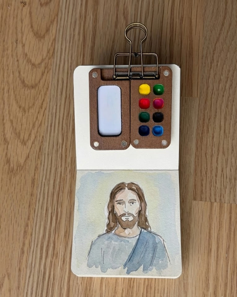 Tobio’s Kits Jesus watercolor painting, painted in a small watercolor sketchbook with soft washes and simple details.