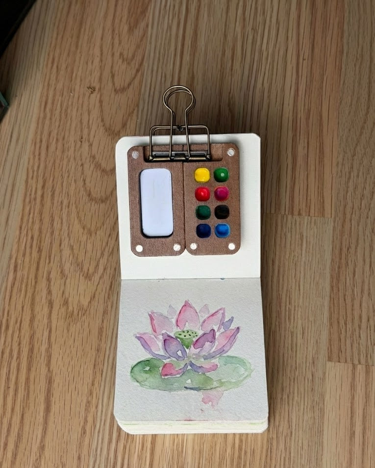 Tobio’s Kits lotus flower watercolor painting, painted in a small watercolor sketchbook with soft washes and simple details.