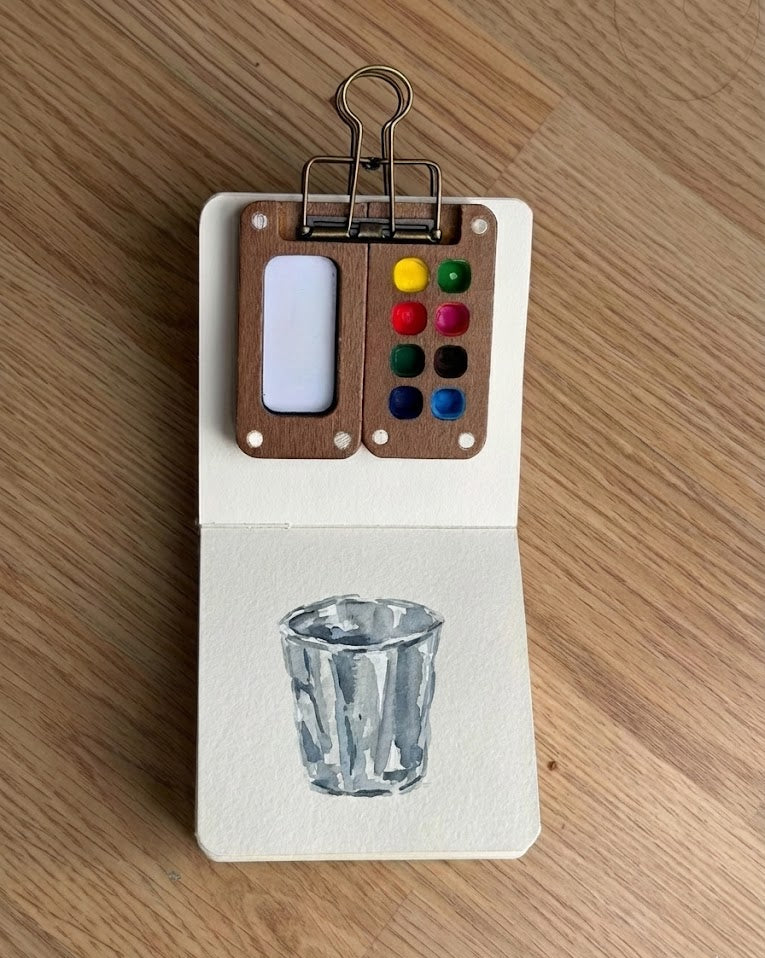 Tobio’s Kits metallic watercolor painting, showing shimmering details in a small watercolor sketchbook.