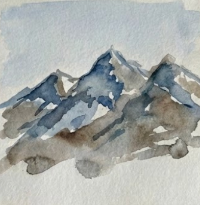 Open miniature watercolor sketchbook with a watercolor mountain painting in blue and brown tones. 