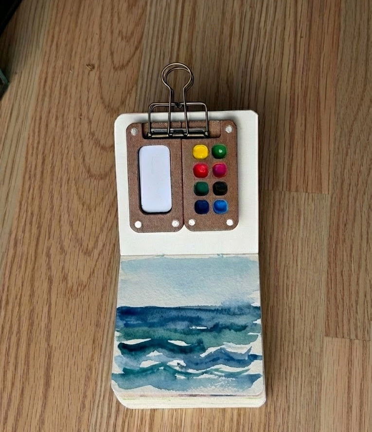 Watercolor ocean design on a wooden surface