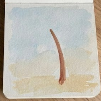 Adding the curved brown trunk over the background wash as the second step in a palm tree watercolor painting.
