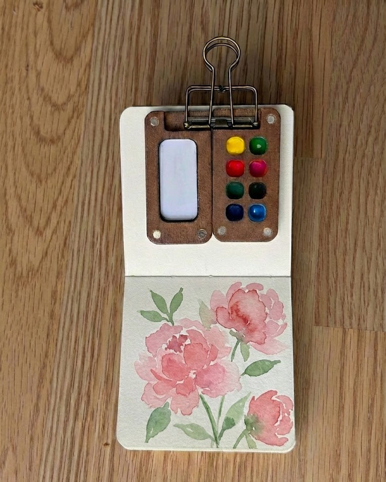 Tobio’s Kits watercolor painting of peonies, painted in a small watercolor sketchbook with soft washes and simple details.