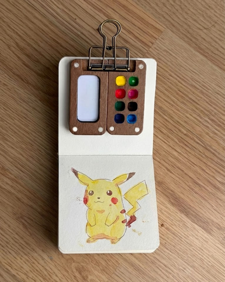 Tobio’s Kits Pokemon watercolor painting, painted in a small watercolor sketchbook with simple details.