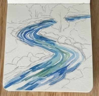 Adding a light blue base wash to a river watercolor painting, showing the flowing water on a sketchbook page.
