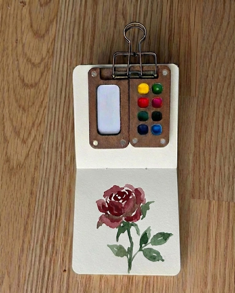 Tobio’s Kits rose watercolor painting, painted in a small watercolor sketchbook with soft washes and simple details.