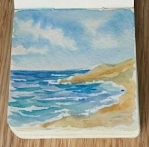 Painting vibrant blue ocean waves and leaving white paper for sea foam, illustrating step three of a beautiful seascape watercolor painting.