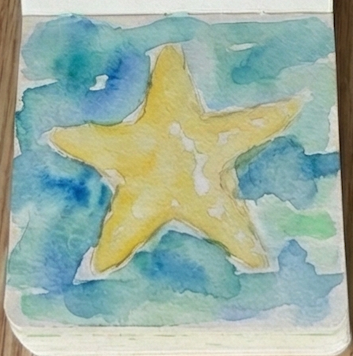 A warm yellow watercolor base wash painted into the starfish area, with small white paper highlights left unpainted.