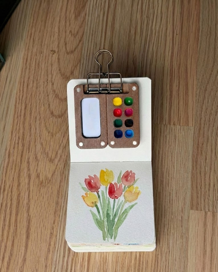 Tobio’s Kits tulip watercolor painting, painted in a small watercolor sketchbook with soft washes and simple details.