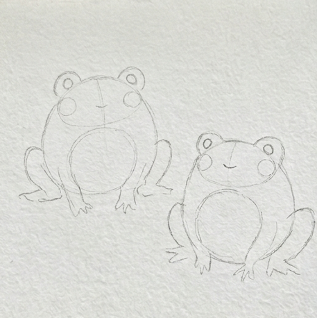 Faint pencil outline sketch of two simple frogs on textured watercolor paper, representing the first stage of a watercolor paintings of frogs study.