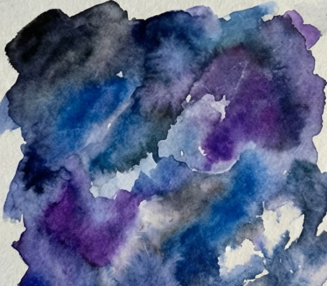 Blue and purple watercolor paints are dropped onto the wet paper, allowing them to bleed and blend together, forming the initial colorful nebula clouds around the dry white patches.