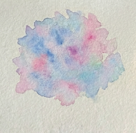 A loose, wet-on-wet watercolor wash of pale blues and pinks forms a roughly rounded cluster shape on the paper, showing the initial application for the flower head with colors bleeding into each other.