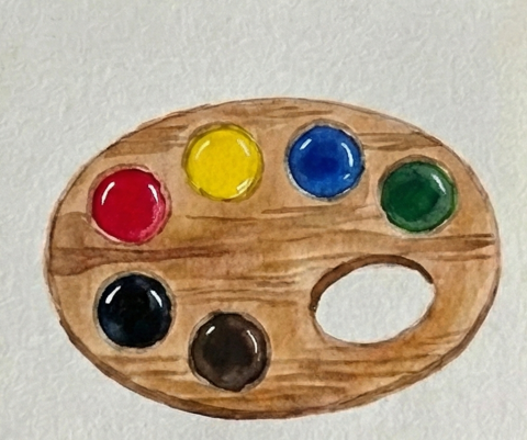 The six paint wells are now filled with glossy dollops of watercolor paint in red, yellow, blue, green, black, and brown, contrasting with the dry wood texture.