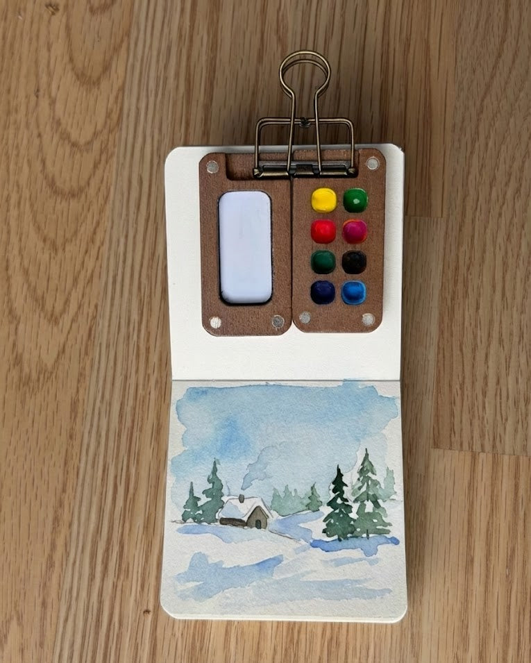 Tobio’s Kits winter watercolor painting, painted in a small watercolor sketchbook with soft washes and simple details.